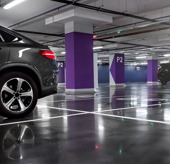 Vehicle Traffic Coating applied to parking garage floor with car parked.